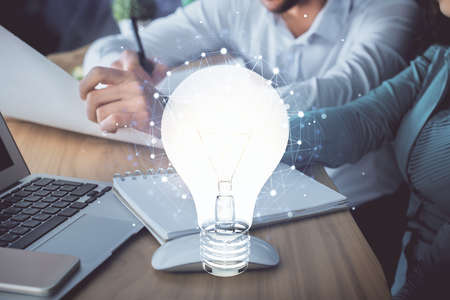 Double exposure of bulb drawing over people taking notes background. Concept of ideaの写真素材