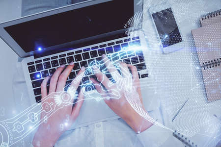 Double exposure of woman hands working on computer and tech theme hologram drawing. Top View. Technology concept.の写真素材
