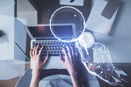 Double exposure of woman hands working on computer and creative hologram drawing. Top View. Start up...
