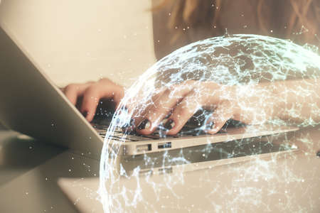 Double exposure of woman hands typing on computer and social network theme hologram drawing. People...