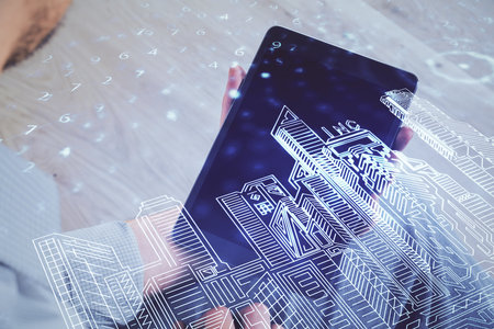 Double exposure of man's hands holding and using a digital device and city drawing.の写真素材