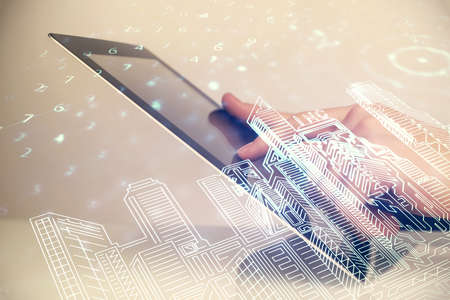 Double exposure of man's hands holding and using a digital device and city drawing.