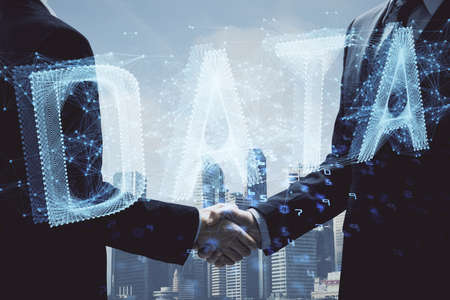 Double exposure of data theme hologram and handshake of two men. Partnership in IT industry concept.