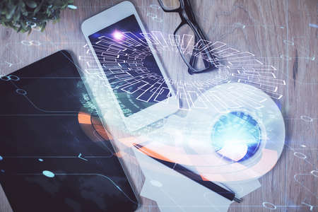Double exposure of technology theme drawing over work table desktop. Top view. Global data analysis concept.の写真素材