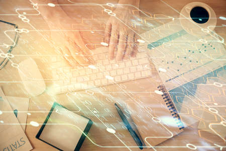 Double exposure of man's hands typing over computer keyboard and data theme hologram drawing. Top...