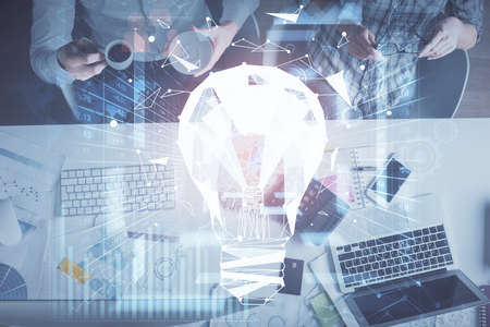 Double exposure of man and woman working together and bulb drawing. Computer background. Top View....
