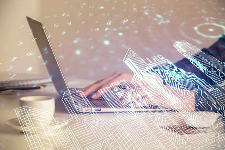 Double exposure of woman hands typing on computer and buildings drawing. Smart-city concept.の写真素材