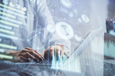 Double exposure of woman hands working on computer and data theme hologram drawing. Tech concept.
