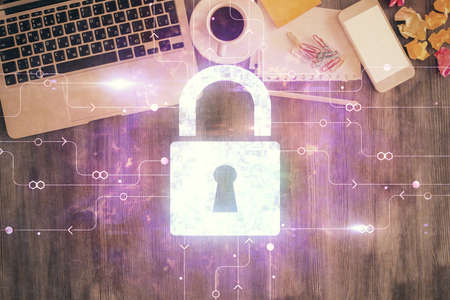 Double exposure of lock hologram drawing over study table background with computer. Concept of data...