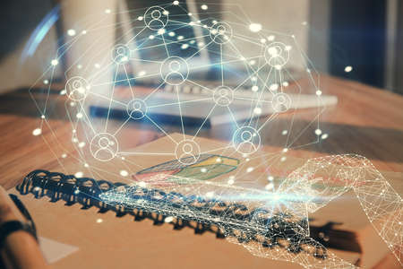 Double exposure of social network theme drawings and desk with open notebook background. Concept of people connectionの写真素材