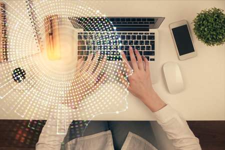 Double exposure of woman working on computer andhuman brain hologram drawing. Top View. Ai concept.の写真素材