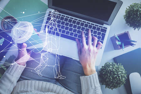 Double exposure of woman hands working on computer and creative hologram drawing. Top View. Start up...