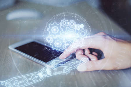 Double exposure of technology sketch hologram and woman holding and using a mobile device.の写真素材