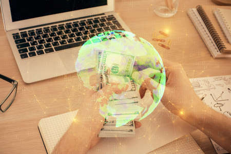 Multi exposure of social network theme drawing hologram and USA dollars bills and man hands.