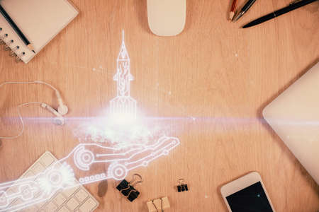 Multi exposure of creative drawing over table with phone. Top view. Concept of startup.