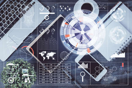 Double exposure of technology theme drawing over work table desktop. Top view. Global data analysis...