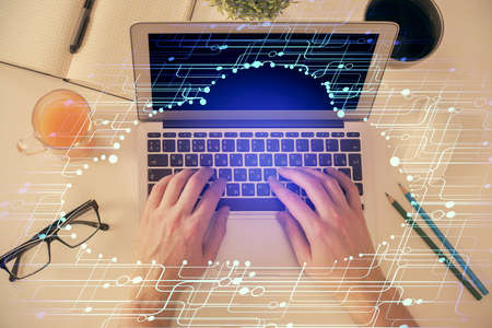 Multi exposure of man's hands typing over computer keyboard and data theme hologram drawing. Top...