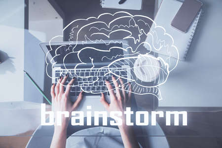 Double exposure of woman hands working on computer and creative hologram drawing. Top View. Start up concept.の写真素材