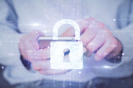 Multi exposure of man's hands holding and using a digital device and lock drawing. Security concept.