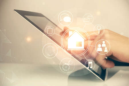 Double exposure of man's hands holding and using a digital device and city drawing.の写真素材