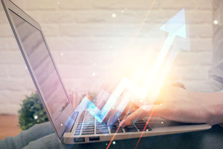 Double exposure of woman hands typing on computer and arrows drawing. Success concept.