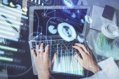 Double exposure of woman hands working on computer and data theme hologram drawing. Tech concept.