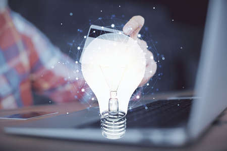 Double exposure of man hands holding a credit card and bulb drawing. Idea E-commerce concept.の写真素材