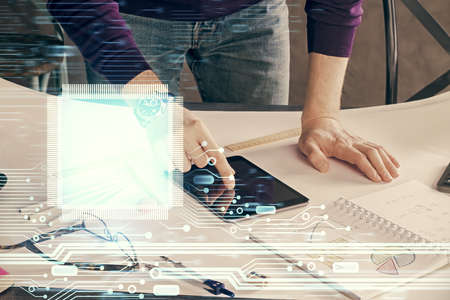 Double exposure of man's hand holding and using a digital device and data theme drawing. Technology...