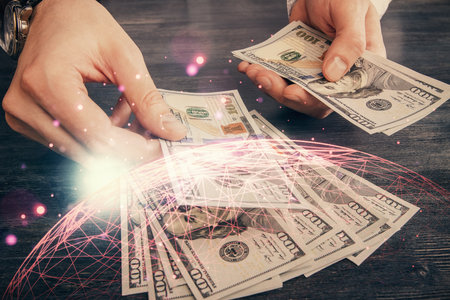 Multi exposure of social network theme drawing hologram and USA dollars bills and man hands.の写真素材