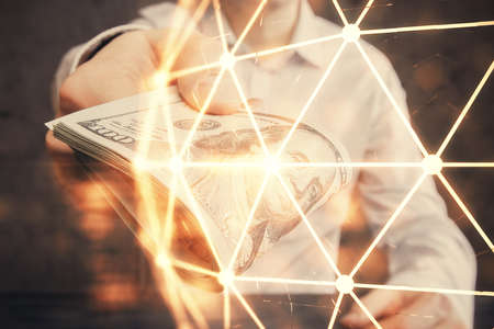 Multi exposure of social network theme drawing hologram and USA dollars bills and man hands.の写真素材