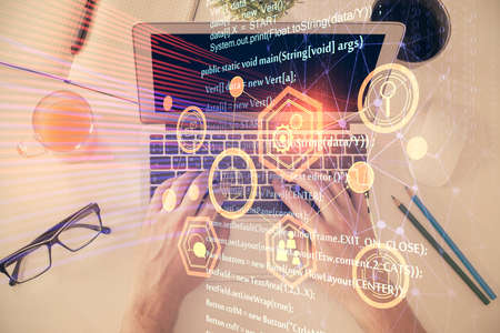 Multi exposure of man's hands typing over computer keyboard and data theme hologram drawing. Top...