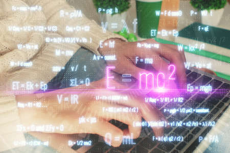 Double exposure of woman hands typing on computer and formula hologram drawing. Education concept.