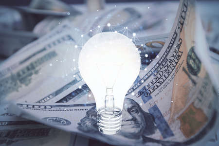 Double exposure of light bulb drawing over usa dollars bill background. Concept of idea.の写真素材