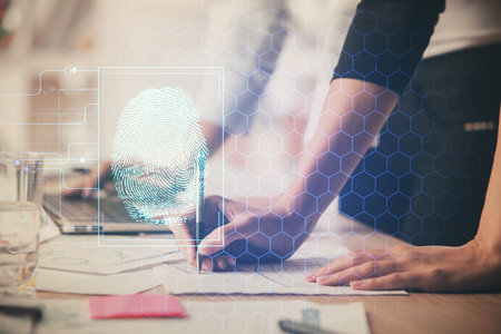 Double exposure of woman hands typing on computer and fingerprint drawing. Security concept.の写真素材