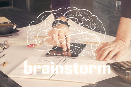 Double exposure of man's hands holding and using a mobile device and creative hologram drawing.の写真素材