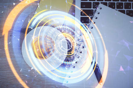 Technology hologram drawing over computer on the desktop background. Top view. Double exposure. Tech concept.の写真素材
