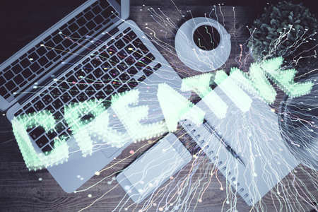 Start up theme drawing over computer on the desktop background. Top view. Double exposure....