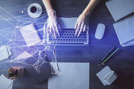 Double exposure of woman hands working on computer and creative hologram drawing. Top View. Start up concept.の写真素材