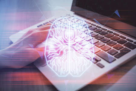 Multi exposure of woman hands working on computer and brain hologram drawing. Ai concept.の写真素材
