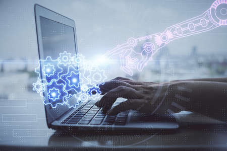 Double exposure of woman hands working on computer and data theme hologram drawing. Tech concept.の写真素材