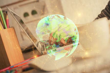 Double exposure of woman hands typing on computer and social network theme hologram drawing. People media concept.の写真素材