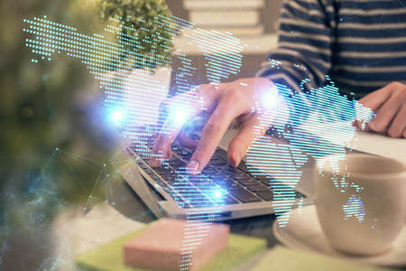 Double exposure of woman hands typing on computer and social network theme hologram drawing. People media concept.の写真素材