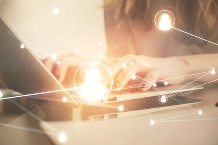 Double exposure of woman hands typing on computer and social network theme hologram drawing. People media concept.の写真素材