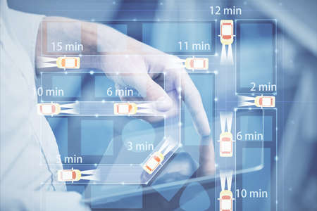 Double exposure of man's hands holding and using a digital device and automobile theme hologram...