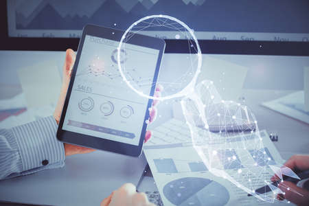 Double exposure of man's hands holding and using a mobile device and creative hologram drawing.