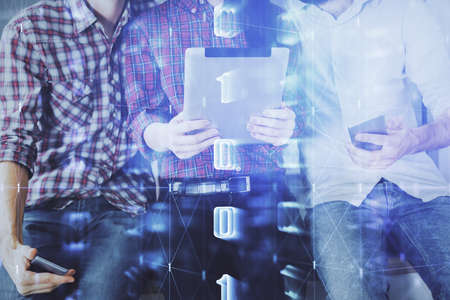 Double exposure of data theme hologram drawing and man and woman working together holding and using a mobile device.の写真素材