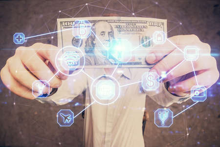 Multi exposure of social network theme drawing hologram and USA dollars bills and man hands.の写真素材