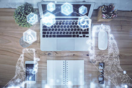 Technology hologram drawing over computer on the desktop background. Top view. Double exposure. Tech concept.の写真素材