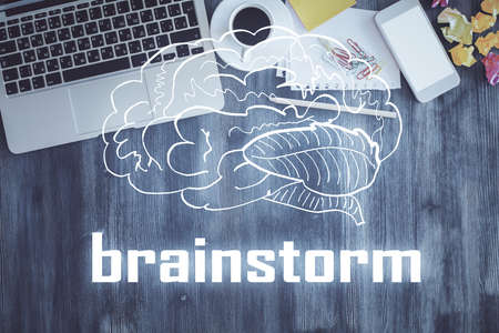 Start up theme drawing over computer on the desktop background. Top view. Double exposure. Brainstorm concept.の写真素材
