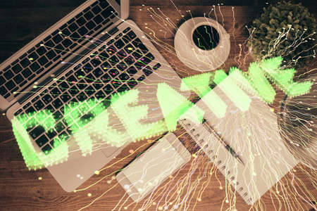 Start up theme drawing over computer on the desktop background. Top view. Double exposure. Brainstorm concept.の写真素材